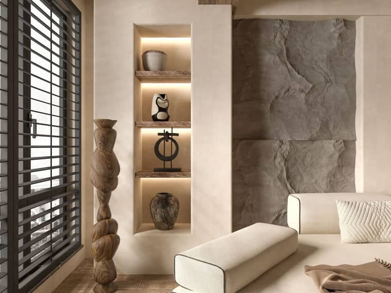 Residence 1: a living room with a split-stone wall and a lit niche.