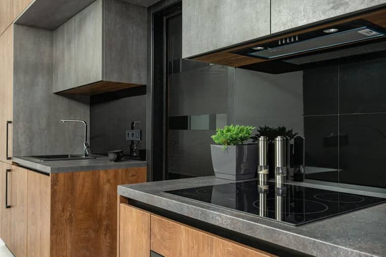Level 2: a kitchen in dark stone and timber.