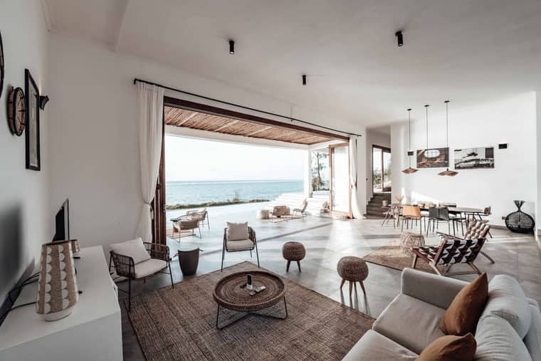 Level 3: a white living room opening to the water.