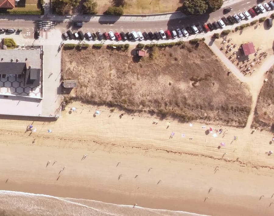 Aerial crop of the vacant sandy lot at Point King before building.
